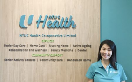 cheryl-lim-in-uniform-at-ntuc-health-signage.jpg