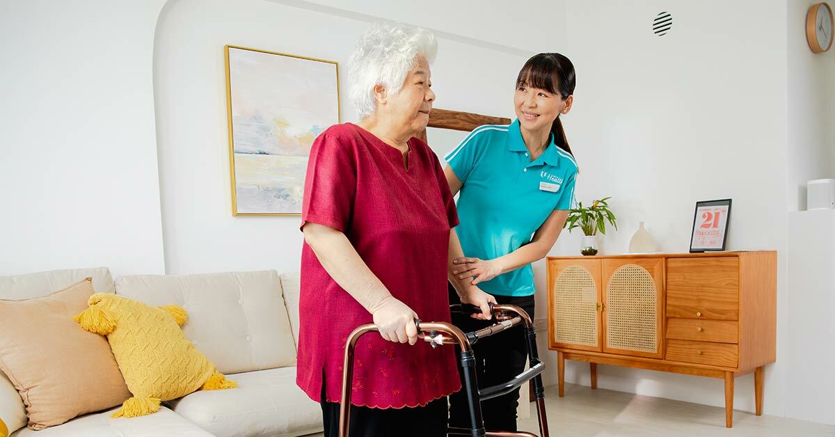 staff-helping-senior-walk-with-frame.jpg